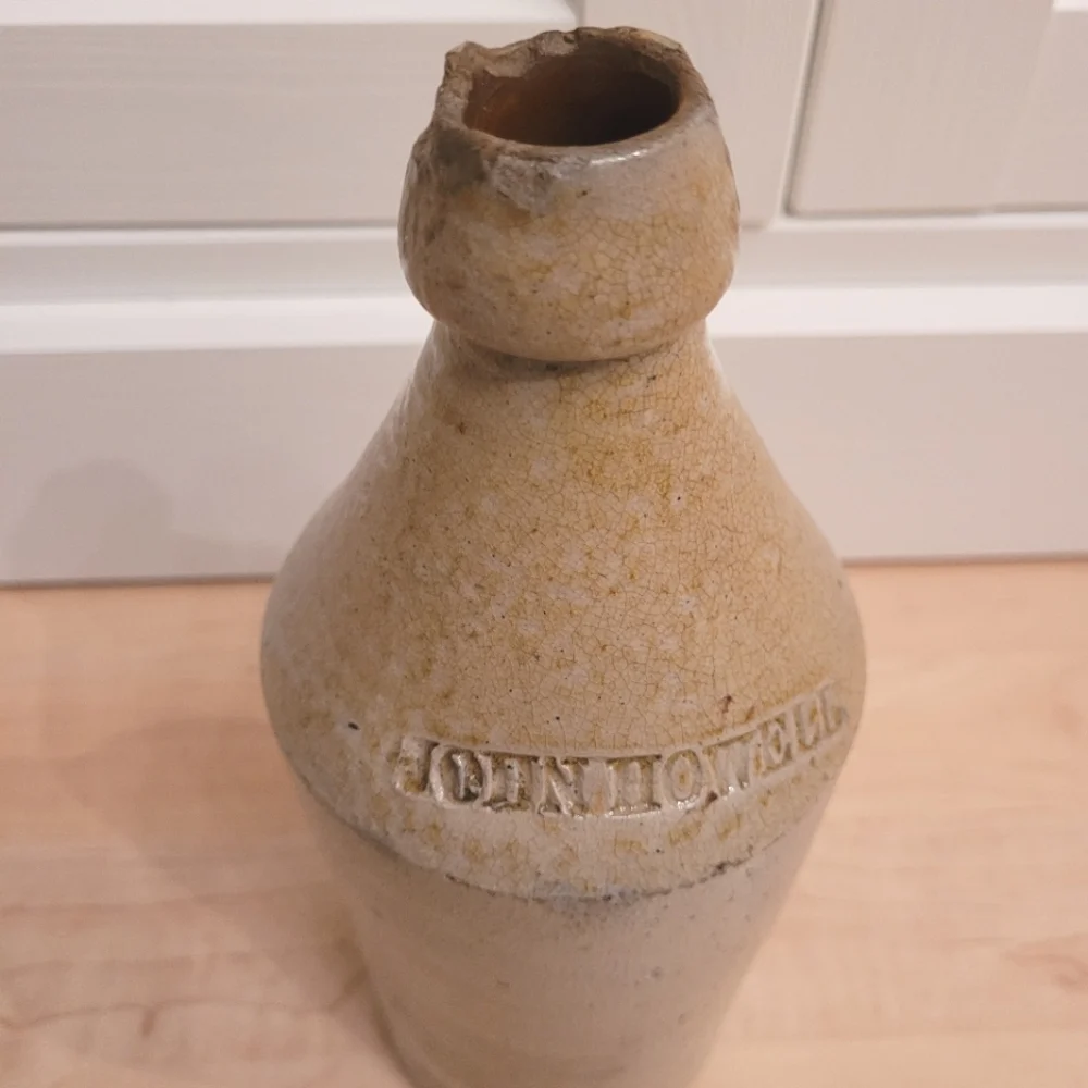 Antique John Howell cream beige pottery stoneware whiskey jug